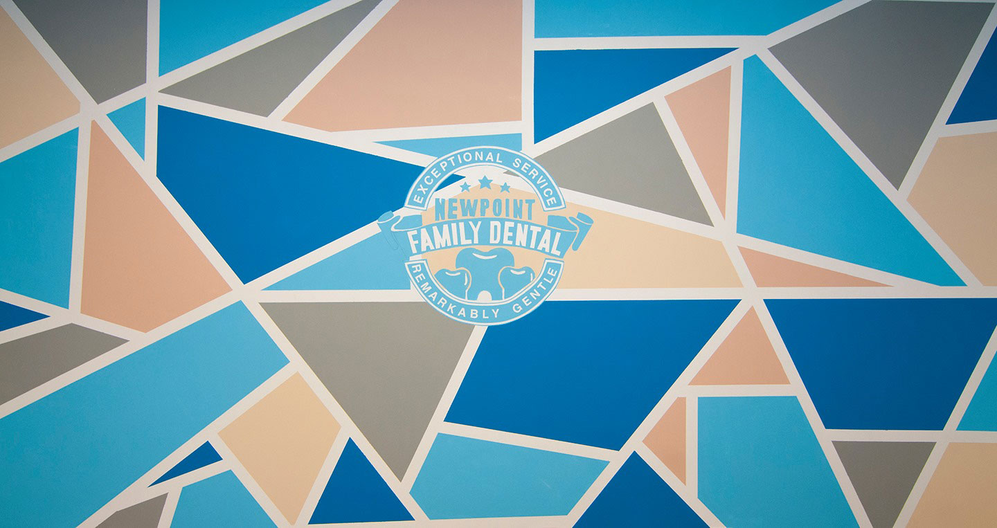 The image features a colorful mosaic wall with geometric shapes and a blue background, adorned with white triangles.